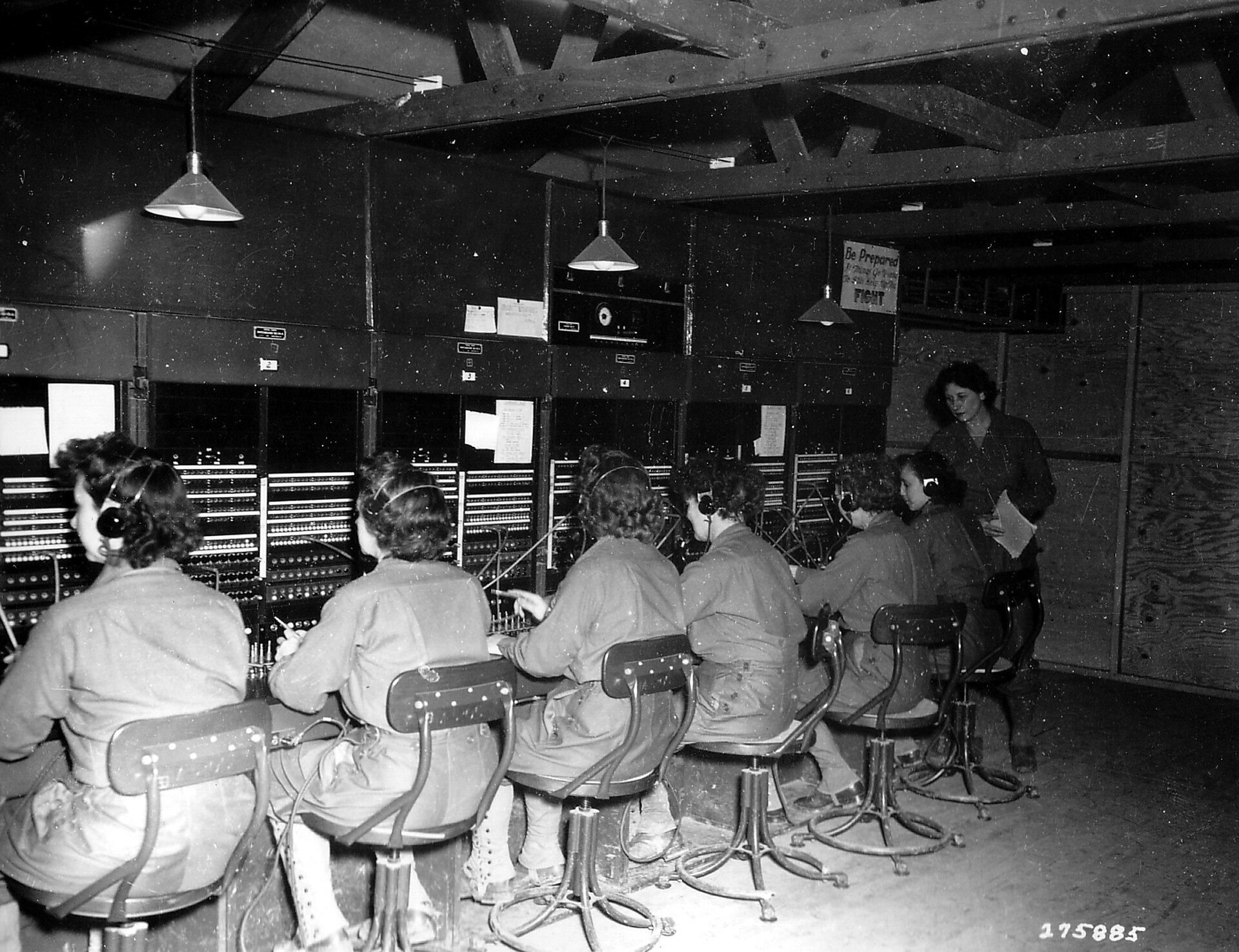 Switchboard operators at work in a wooden exchange room, 1944